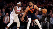 Mar 17, 2025; New York, New York, USA; New York Knicks center Karl-Anthony Towns (32) controls the ball against Miami Heat center Bam Adebayo (13) during the fourth quarter at Madison Square Garden. Mandatory Credit: Brad Penner-Imagn Images