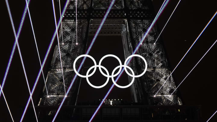 Jul 26, 2024; Paris, FRANCE;  Celine Dion performs under the Olympic rings on the Eiffel Tower during the Opening Ceremony for the Paris 2024 Olympic Summer Games along the Seine River. 