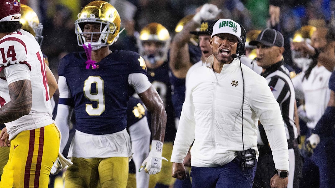 Oct 18, 2025; South Bend, Indiana, USA; Notre Dame Fighting Irish head coach Marcus Freeman and the  defense celebrates a turnover on downs in second half against the Southern California Trojans at Notre Dame Stadium. Mandatory Credit: Trevor Ruszkowski-Imagn Images