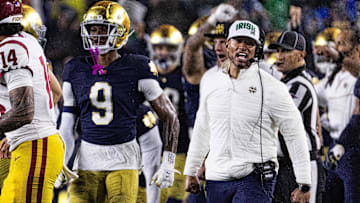 Oct 18, 2025; South Bend, Indiana, USA; Notre Dame Fighting Irish head coach Marcus Freeman and the  defense celebrates a turnover on downs in second half against the Southern California Trojans at Notre Dame Stadium. Mandatory Credit: Trevor Ruszkowski-Imagn Images