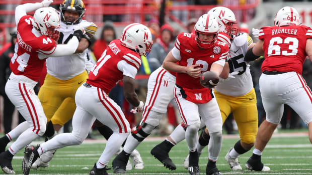 Nebraska Cornhuskers quarterback Chubba Purdy (12) hands off to running back Emmett Johnson (21)