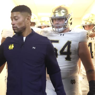 Nov 15, 2025; Pittsburgh, Pennsylvania, USA;  Notre Dame Fighting Irish head coach Marcus Freeman leads the team from the locker room to play the Pittsburgh Panthers at Acrisure Stadium. 