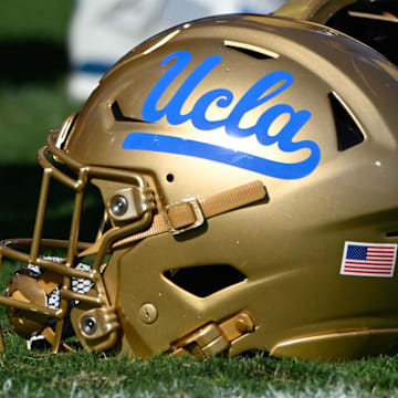 Nov 30, 2024; Pasadena, California, USA; UCLA Bruins helmets during pregame warmups before playing the Fresno State Bulldogs at Rose Bowl. Mandatory Credit: Robert Hanashiro-Imagn Images