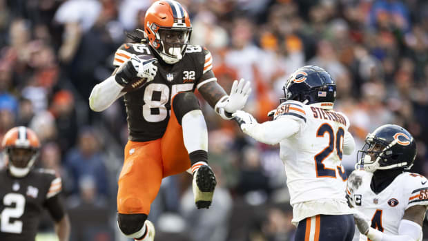 Cleveland Browns tight end David Njoku leaps to avoid a tackle by Chicago Bears cornerback Tyrique Stevenson 