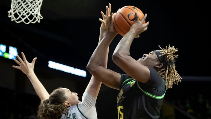 Oregon center Phillipina Kyei is fouled by Portland State forward Lana Wenger.