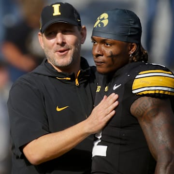 Iowa’s offensive coordinator Tim Lester greets running back Kaleb Johnson (2) before the Hawkeyes play Washington Saturday, Oct. 12, 2024 at Kinnick Stadium in Iowa City, Iowa.