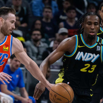 Apr 5, 2024; Indianapolis, Indiana, USA; Oklahoma City Thunder forward Gordon Hayward (33) dribbles the ball while Indiana Pacers forward Aaron Nesmith (23) defends in the first half at Gainbridge Fieldhouse. Mandatory Credit: Trevor Ruszkowski-USA TODAY Sports