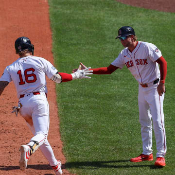 Boston Red Sox left fielder Jarren Duran (16) high fives Boston Red Sox third base coach Kyle Hudson (84) after hitting a solo home run during the eighth inning against the Atlanta Braves at Fenway Park on June 5.