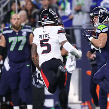 Oct 20, 2025; Seattle, Washington, USA; Seattle Seahawks wide receiver Cooper Kupp (10) runs after a catch against Houston Texans safety Jalen Pitre (5) during the first quarter at Lumen Field. Mandatory Credit: Kevin Ng-Imagn Images