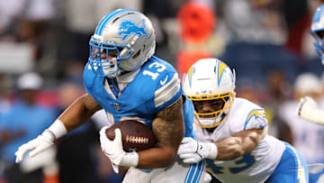 Jul 31, 2025; Canton, Ohio, USA; Los Angeles Chargers linebacker Troy Dye (43) tackles Detroit Lions running back Craig Reynolds (13) in the first quarter at Tom Benson Hall of Fame Stadium. Mandatory Credit: Scott Galvin-Imagn Images