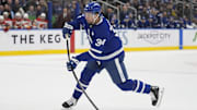 Oct 28, 2025; Toronto, Ontario, CAN; Toronto Maple Leafs forward Auston Matthews (34) goes to shoot the puck against the Calgary Flames during the first period at Scotiabank Arena. Mandatory Credit: John E. Sokolowski-Imagn Images