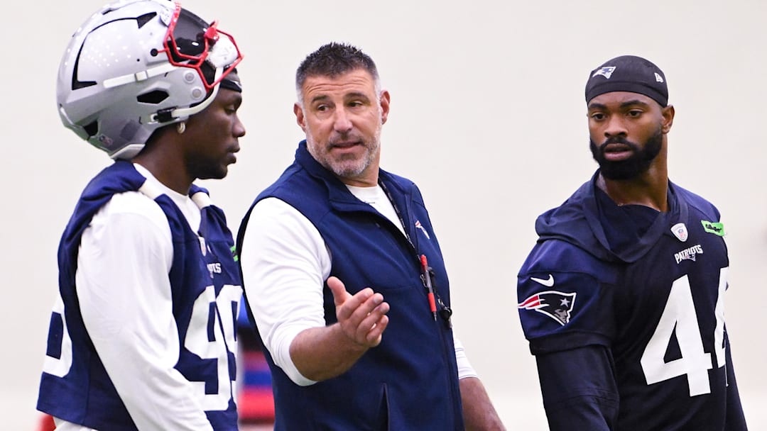 Jun 10, 2025; Foxborough, MA, USA; New England Patriots head coach Mike Vrabel speaks to defensive end Keion White (99) and linebacker K'Lavon Chaisson (44) after minicamp held in the WIN Field House at Gillette Stadium. Mandatory Credit: Eric Canha-Imagn Images