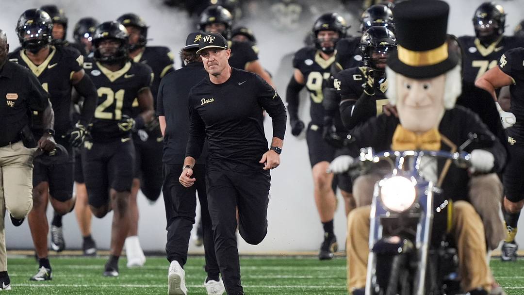 Sep 18, 2026; Winston-Salem, North Carolina, USA;  Wake Forest Demon Deacons head coach Jake Dickert leads his team onto the field against the Miami (FL) Hurricanes during the first half at Allegacy Federal Credit Union Stadium.  Mandatory Credit: Jim Dedmon-Imagn Images