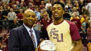 Florida State Seminoles head coach Leonard Hamilton congratulates Florida State Seminoles guard Trent Forrest (3) for scoring 1,000 points and gives him a ball to commemorate the occasion