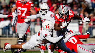 Ohio State Buckeyes running back Bo Jackson (25) runs through Rutgers Scarlet Knights defensive back Kaj Sanders (5) during the NCAA football game at Ohio Stadium in Columbus on Nov. 22, 2025. Ohio State won 42-9.