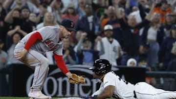 May 14, 2025; Detroit, Michigan, USA;  Detroit Tigers third baseman Andy Ibáñez (77) dives in safely at third ahead of the tag by Boston Red Sox third baseman Alex Bregman (2) in the ninth inning at Comerica Park. Mandatory Credit: Rick Osentoski-Imagn Images