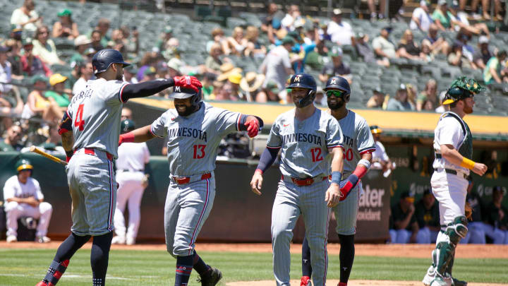Minnesota Twins right fielder Manuel Margot (13) gets a hug from Carlos Correa (4) after hitting a three-run home run against the Oakland Athletics during the second inning at Oakland-Alameda County Coliseum in Oakland, Calif., on June 22, 2024. 