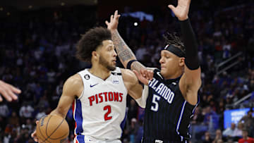 Oct 19, 2022; Detroit, Michigan, USA;  Detroit Pistons guard Cade Cunningham (2) is defended by Orlando Magic forward Paolo Banchero (5): Rick Osentoski-Imagn Images