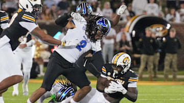 Sep 7, 2024; Columbia, Missouri, USA; Missouri Tigers running back Marcus Carroll (9) runs the ball as Buffalo Bulls linebacker Red Murdock (2) attempts the tackle during the second half at Faurot Field at Memorial Stadium. Mandatory Credit: Denny Medley-Imagn Images