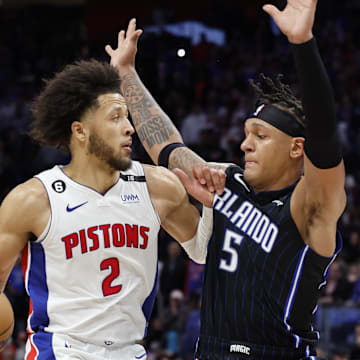 Oct 19, 2022; Detroit, Michigan, USA;  Detroit Pistons guard Cade Cunningham (2) is defended by Orlando Magic forward Paolo Banchero (5) in the second half at Little Caesars Arena. Mandatory Credit: Rick Osentoski-Imagn Images