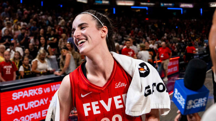 Jul 6, 2024; Indianapolis, Indiana, USA; Indiana Fever guard Caitlin Clark (22) smiles in an interview after becoming the first rookie to have a triple-double during a game against the New York Liberty at Gainbridge Fieldhouse. Mandatory Credit: Grace Smith/INDIANAPOLIS STAR-USA TODAY Sports