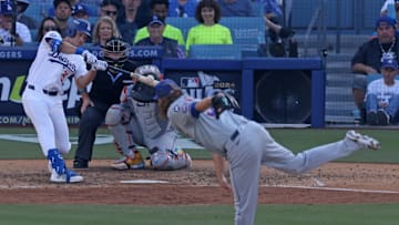Oct 14, 2024; Los Angeles, California, USA; Los Angeles Dodgers outfielder Tommy Edman (25) hits a single against the New York Mets in the eighth inning during game two of the NLCS for the 2024 MLB Playoffs at Dodger Stadium. 