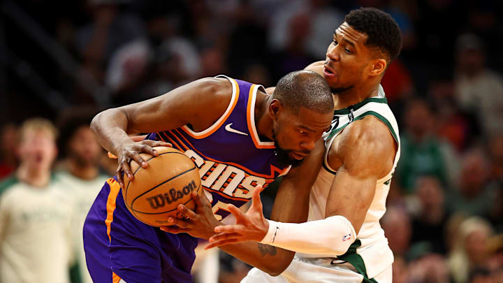 Mar 24, 2025; Phoenix, Arizona, USA; Phoenix Suns forward Kevin Durant (35) handles the ball against Milwaukee Bucks forward Giannis Antetokounmpo (34) during the fourth quarter at Footprint Center. Mandatory Credit: Mark J. Rebilas-Imagn Images