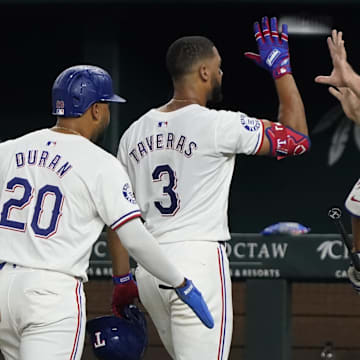 Aug 31, 2024; Arlington, Texas, USA; Texas Rangers center fielder Leody Taveras (3) high fives manager Bruce Bochy (15) as he leaves the field after hitting a walk-off single during the ninth inning against the Oakland Athletics at Globe Life Field. Mandatory Credit: Raymond Carlin III-Imagn Images