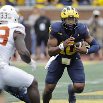 Sep 7, 2024; Ann Arbor, Michigan, USA; Michigan Wolverines quarterback Alex Orji (10) rushes against the Texas Longhorns at Michigan Stadium. Mandatory Credit: Rick Osentoski-Imagn Images