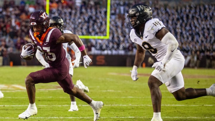 Oct 14, 2023; Blacksburg, Virginia, USA; Virginia Tech Hokies wide receiver Jaylin Lane (83) scores a touchdown against Wake Forest Demon Deacons defensive back Chelen Garnes (9) during the fourth quarter at Lane Stadium. Mandatory Credit: Peter Casey-USA TODAY Sports