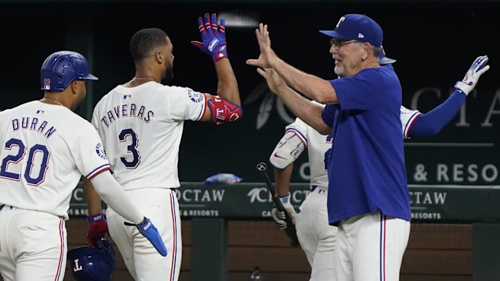 Aug 31, 2024; Arlington, Texas, USA; Texas Rangers center fielder Leody Taveras (3) high fives manager Bruce Bochy (15) as he leaves the field after hitting a walk-off single during the ninth inning against the Oakland Athletics at Globe Life Field. Mandatory Credit: Raymond Carlin III-Imagn Images