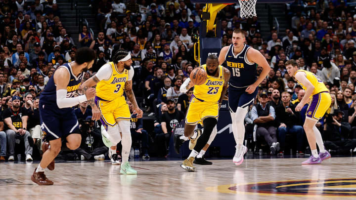 Apr 29, 2024; Denver, Colorado, USA; Los Angeles Lakers forward LeBron James (23) dribbles the ball up court ahead of Denver Nuggets center Nikola Jokic (15) as forward Anthony Davis (3) and guard Jamal Murray (27) defend in the first quarter during game five of the first round for the 2024 NBA playoffs at Ball Arena. Mandatory Credit: Isaiah J. Downing-USA TODAY Sports