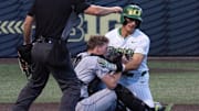 Oregon’s Anson Aroz, right, collides with Utah Valley catcher Mason Strong at the plate in the eighth inning of the Eugene NCAA Regional at PK Park.