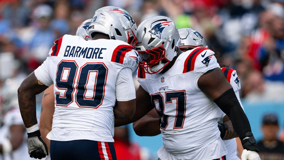 Patriots defensive end Milton Williams and Christian Barmore celebrate a sack.