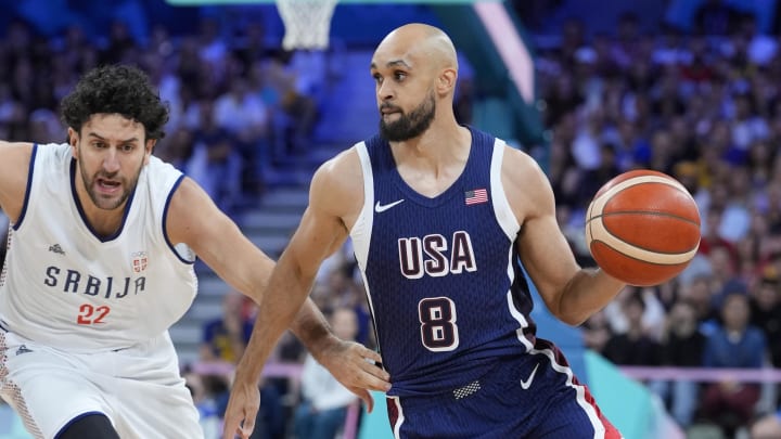 Jul 28, 2024; Villeneuve-d'Ascq, France; United States guard Derrick White (8) drives against Serbia point guard Vasilije Micic (22) in the second quarter during the Paris 2024 Olympic Summer Games at Stade Pierre-Mauroy. Mandatory Credit: John David Mercer-USA TODAY Sports