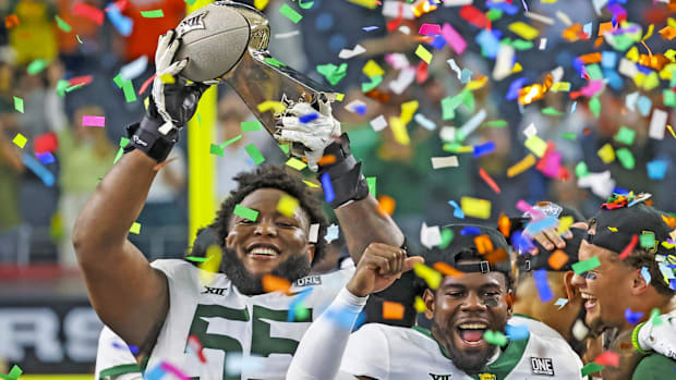 Xavier Newman-Johnson (55) celebrates a win against Oklahoma State in the Big 12 Conference title.