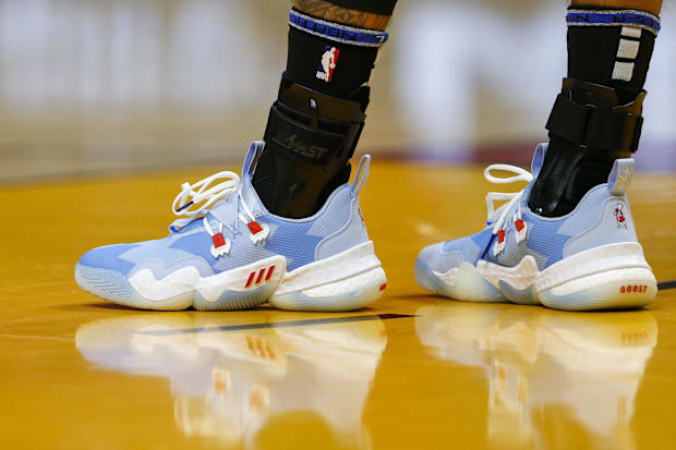 Atlanta Hawks guard Trae Young's blue and white adidas basketball shoes.