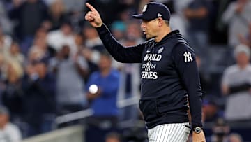 Oct 30, 2024; New York, New York, USA; New York Yankees manager Aaron Boone (17) signals to the bull pen for a pitching change during the seventh inning against the Los Angeles Dodgers in game four of the 2024 MLB World Series at Yankee Stadium. Mandatory Credit: Brad Penner-Imagn Images
