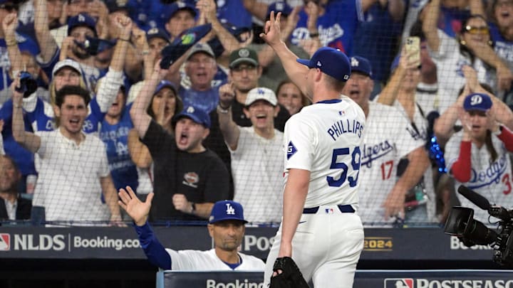 Oct 11, 2024; Los Angeles, California, USA; Los Angeles Dodgers pitcher Evan Phillips (59) reacts after being relieved in the seventh inning against the San Diego Padres during game five of the NLDS for the 2024 MLB Playoffs at Dodger Stadium. Mandatory Credit: Jayne Kamin-Oncea-Imagn Images