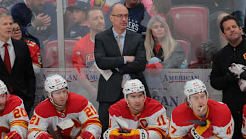 Mar 1, 2025; Sunrise, Florida, USA; Calgary Flames head coach Ryan Huska looks on from the bench against the Florida Panthers during the second period at Amerant Bank Arena. Mandatory Credit: Sam Navarro-Imagn Images