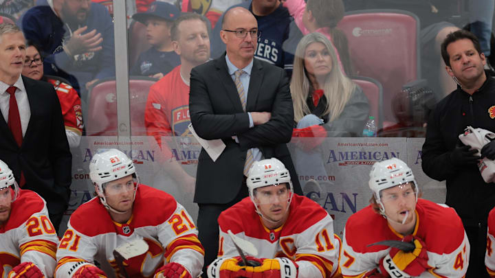 Mar 1, 2025; Sunrise, Florida, USA; Calgary Flames head coach Ryan Huska looks on from the bench against the Florida Panthers during the second period at Amerant Bank Arena. Mandatory Credit: Sam Navarro-Imagn Images