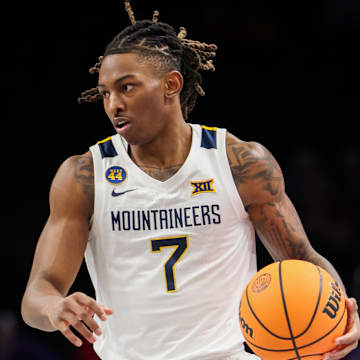 Mar 12, 2025; Kansas City, MO, USA; West Virginia Mountaineers guard Javon Small (7) brings the ball up court during the first half against the Colorado Buffaloes at T-Mobile Center. Mandatory Credit: William Purnell-Imagn Images