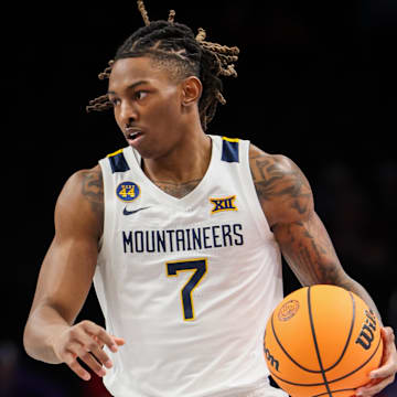 Mar 12, 2025; Kansas City, MO, USA; West Virginia Mountaineers guard Javon Small (7) brings the ball up court during the first half against the Colorado Buffaloes at T-Mobile Center. Mandatory Credit: William Purnell-Imagn Images