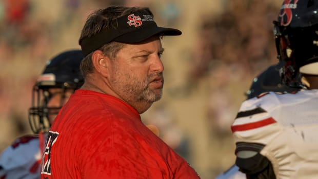 South Sumter head coach Ty Lawrence talks with his players 