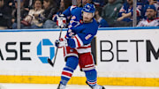 Mar 22, 2025; New York, New York, USA; New York Rangers center J.T. Miller (8) clears the puck against the Vancouver Canucks during the second period at Madison Square Garden. Mandatory Credit: Danny Wild-Imagn Images