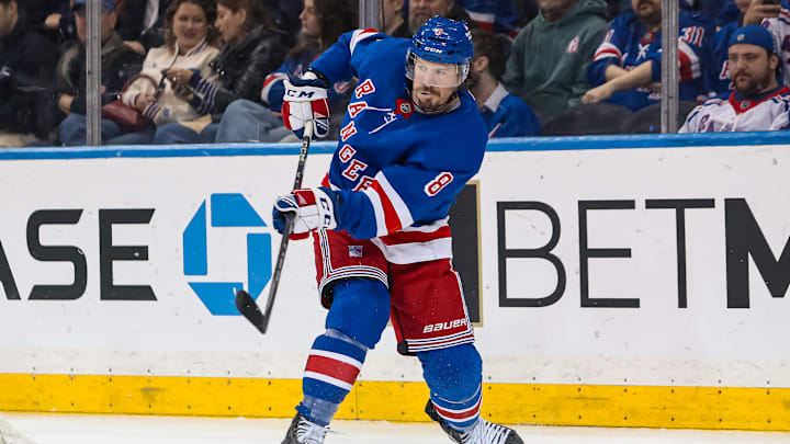Mar 22, 2025; New York, New York, USA; New York Rangers center J.T. Miller (8) clears the puck against the Vancouver Canucks during the second period at Madison Square Garden. Mandatory Credit: Danny Wild-Imagn Images