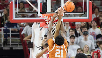 Feb 26, 2025; Fayetteville, Arkansas, USA; Arkansas Razorbacks forward Jonas Aidoo (9) blocks a shot attempt by Texas Longhorns forward Ze’Rik Onyema (21) during the first half at Bud Walton Arena. Mandatory Credit: Nelson Chenault-Imagn Images
