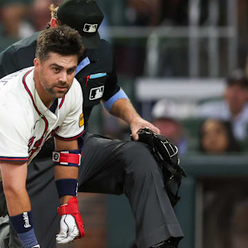 Atlanta Braves second baseman Whit Merrifield on ground after being hit in the head with a pitch against the Colorado Rockies on Tuesday.