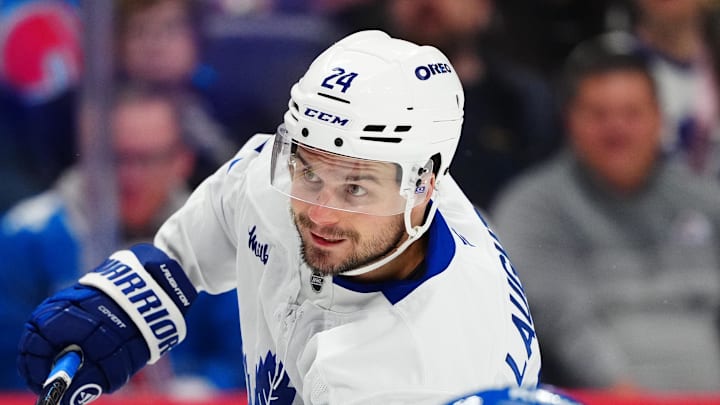 Jan 12, 2026; Denver, Colorado, USA; Toronto Maple Leafs center Scott Laughton (24) takes a shot on goal in the first period at Ball Arena. Mandatory Credit: Ron Chenoy-Imagn Images