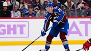 Nov 9, 2024; Denver, Colorado, USA; Colorado Avalanche center Nathan MacKinnon (29) prepares to pass the puck in the second period against the Carolina Hurricanes at Ball Arena. Mandatory Credit: Ron Chenoy-Imagn Images